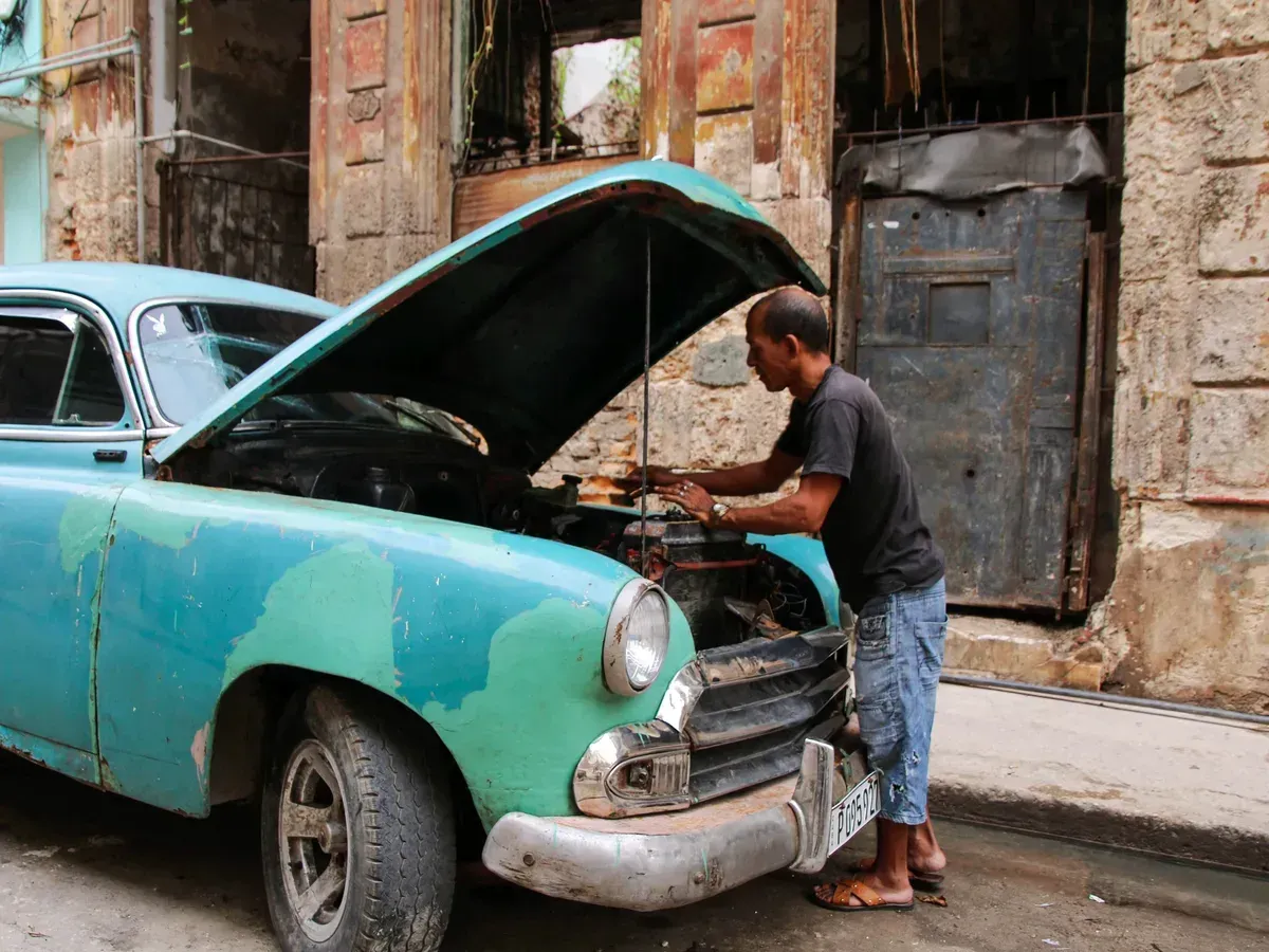 A mechanic working in an engine bay